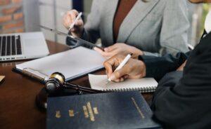 business people and lawyers discussing contract papers sitting at the table. Concepts of law, advice, legal services. in morning light