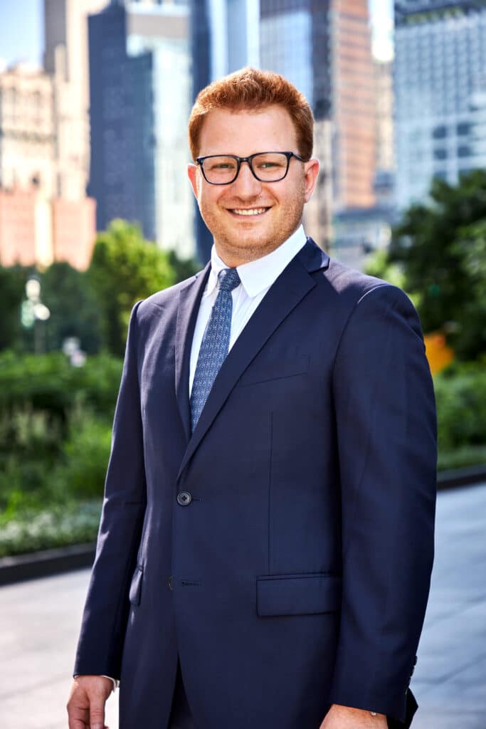 Evan Lloyd's headshot outside of Shulman & Hill's Manhattan office