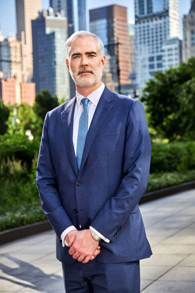 Michael Zogala's headshot in front of Shulman & Hill's Manhattan Office