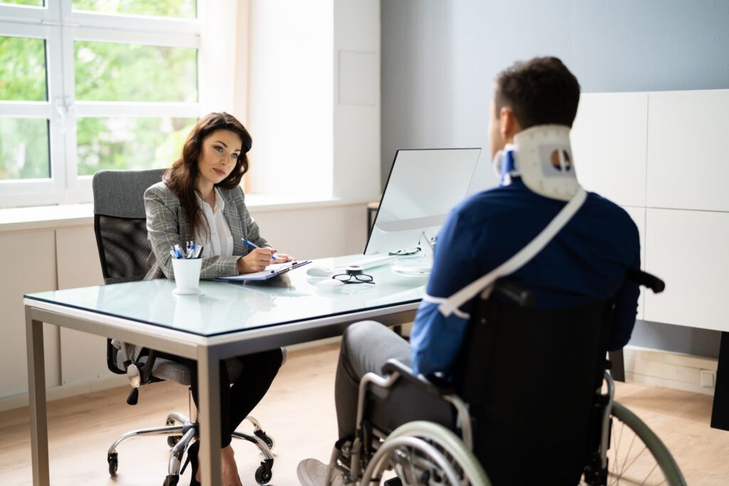 a patient on wheel chair talking to an official