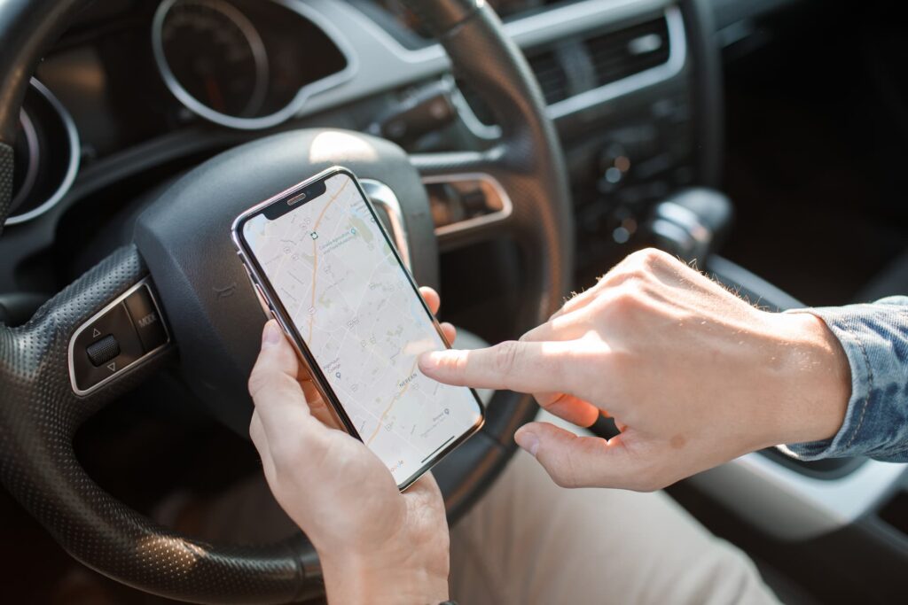 a person holding a cell phone in a car