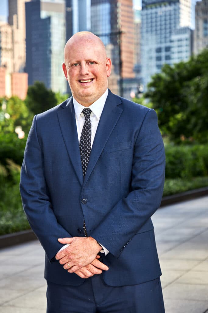 Michael Edelman's headshot in front of Shulman & Hill's Manhattan Office