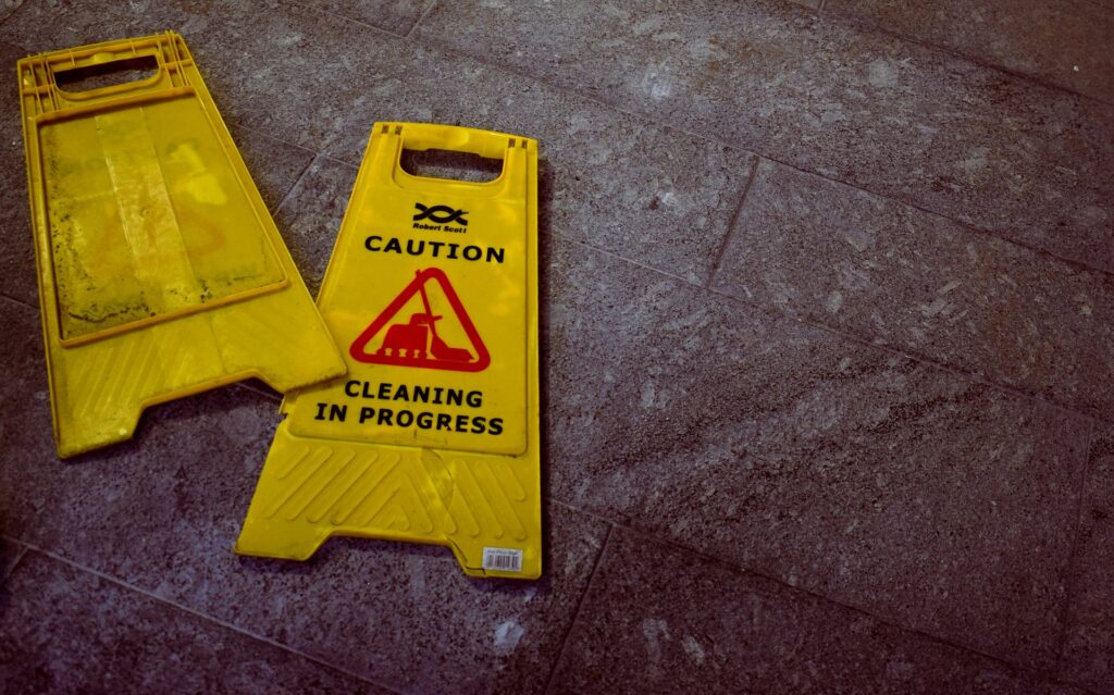 a yellow caution sign on floor