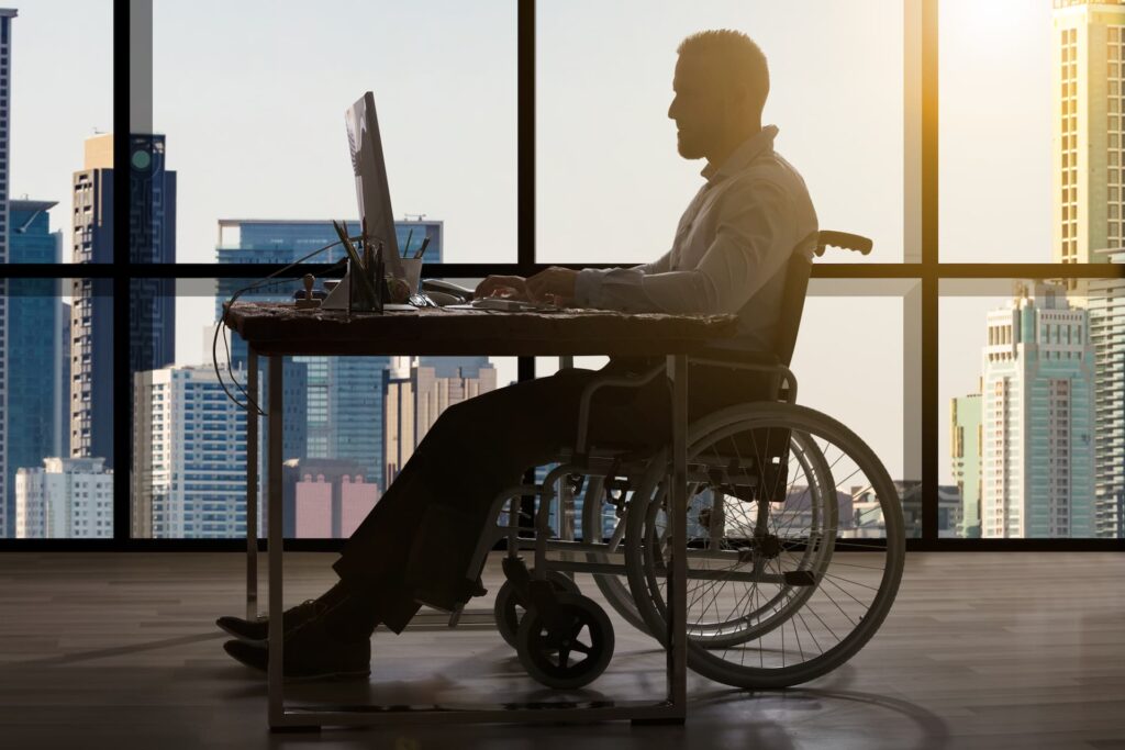 a person in a wheelchair using a computer