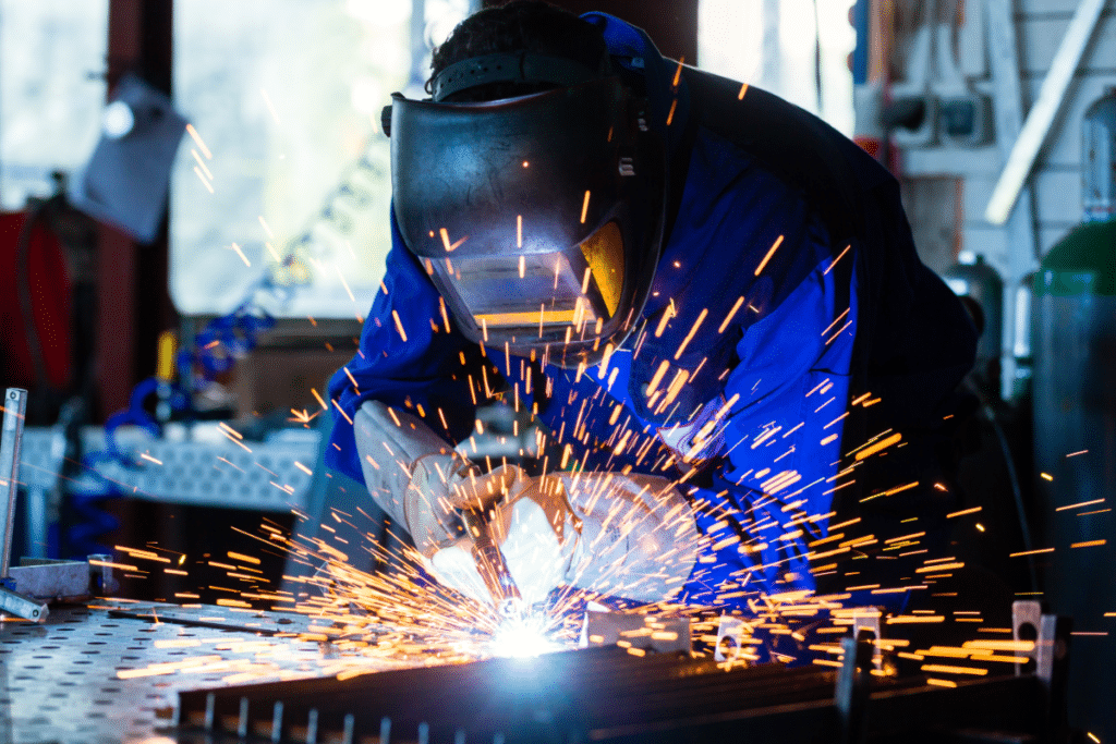 a person welding a metal piece