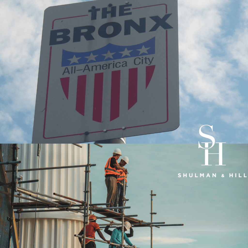 Bronx All-America City Sign with construction workers high up on scaffolding below