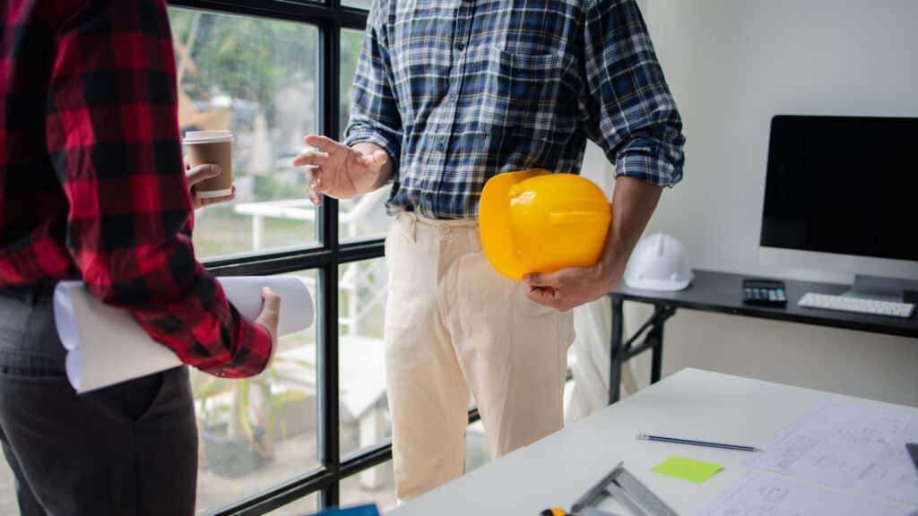 architects discussing house plan draft