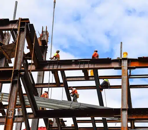 Construction workers on steel beams in construction site of skyscraper in New York
