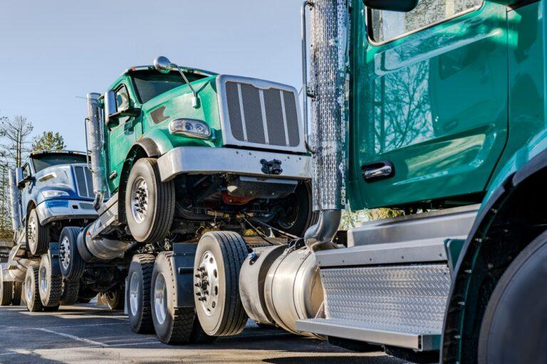 Semi truck with trailer attached towing other semi trucks after a crash where someone besides the truck driver was liable.