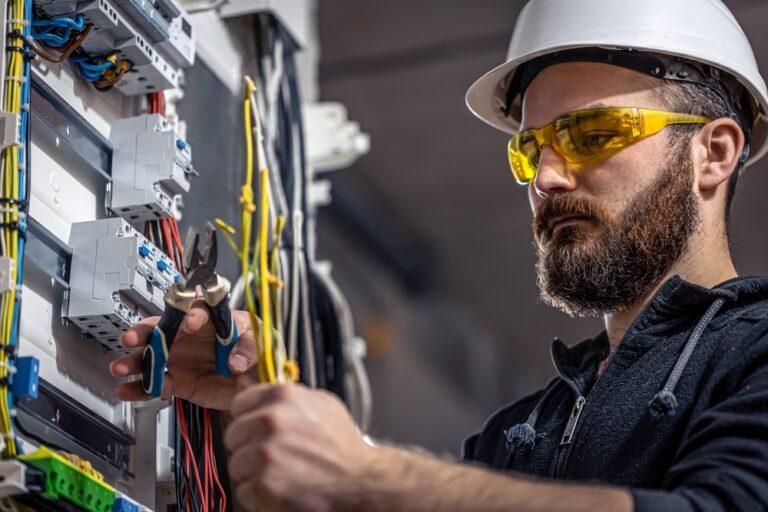 A worker handling electrical cables. Learn about who is liable for an electrocution on a job site.
