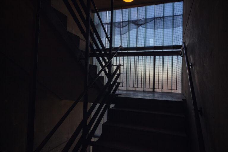 Photo of a dark stairwell. Find out if poor lighting can support a negligent security claim.
