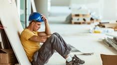 A worried man wondering what to do if his workers’ comp doctor sends him back to work too
